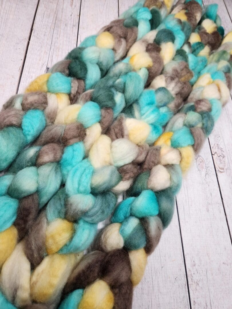 A skein of Disco Date ~ 100g Hand-Dyed Luxury Combed Top Fiber.