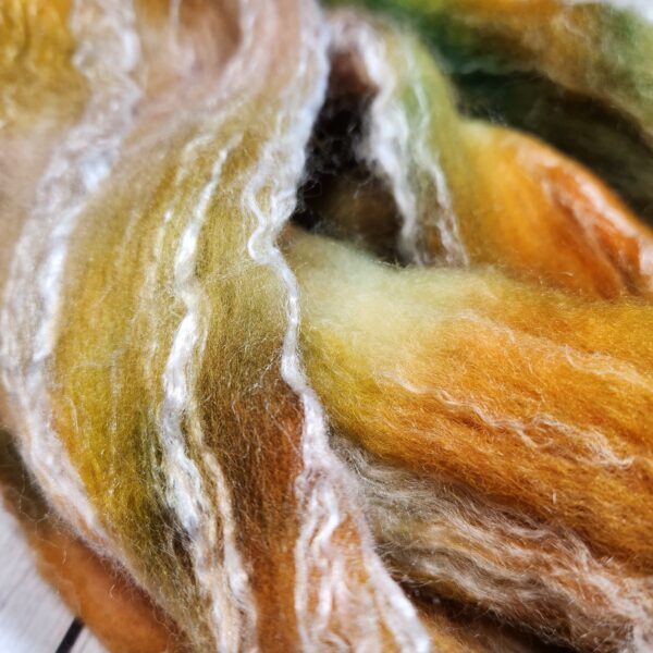Vintage Gold A close up of a skein of merino wool.