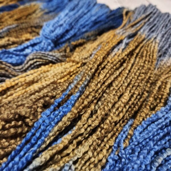 A close up of some blue and brown yarn.