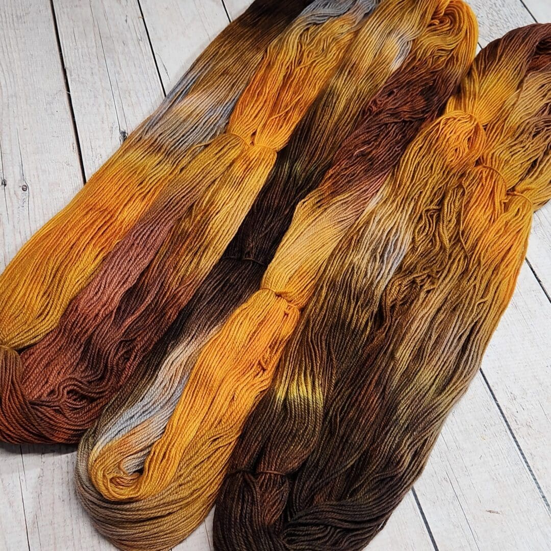 Three skeins of yarn in different colors.