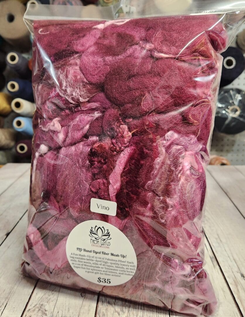 A bag of "Vino" FLD Luxury Fiber MashUp™ petals on a table.