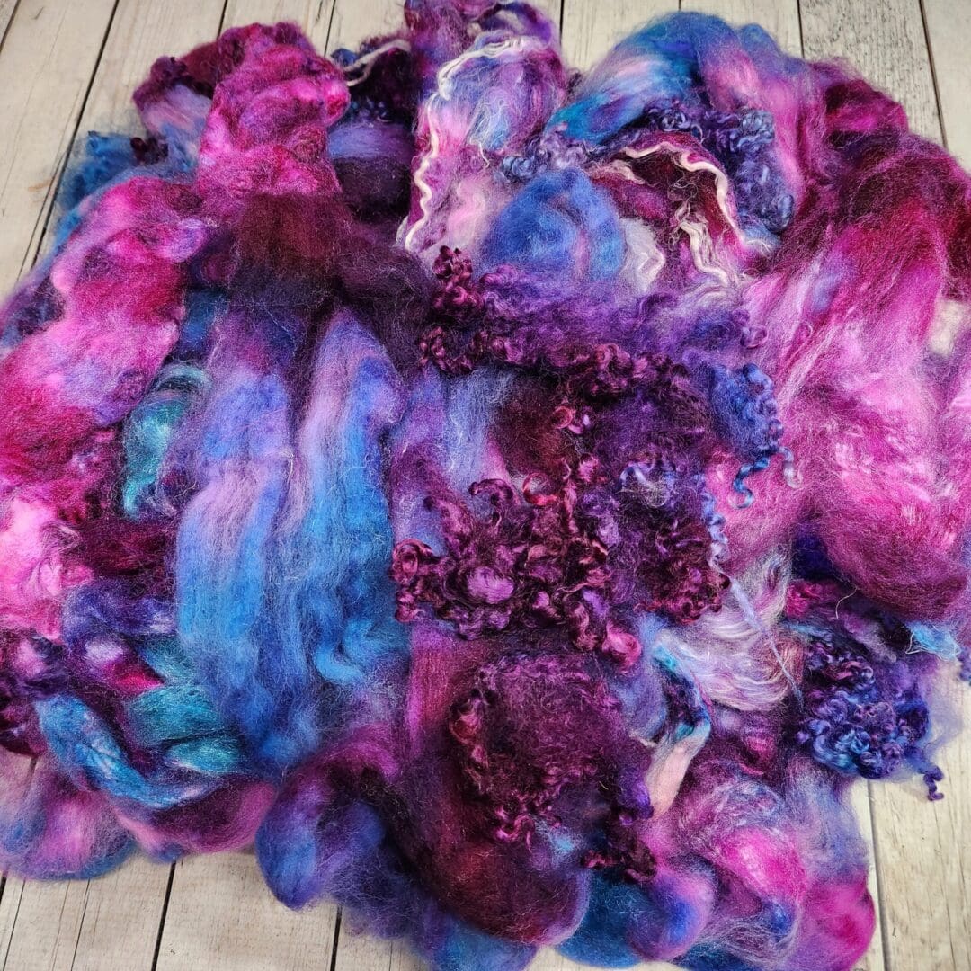 Purple, pink, and blue wool fibers.